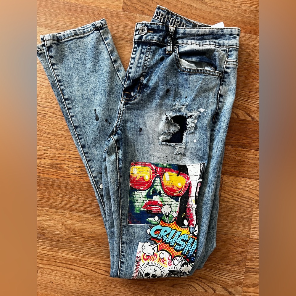 #103.   Rutherford Men's Light Blue Distressed Denim Jeans with Graphic Patch
